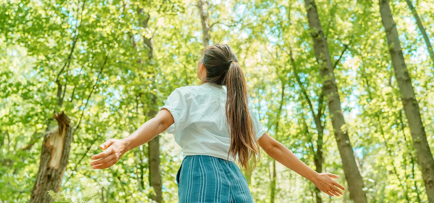 Woman taking in the forest.